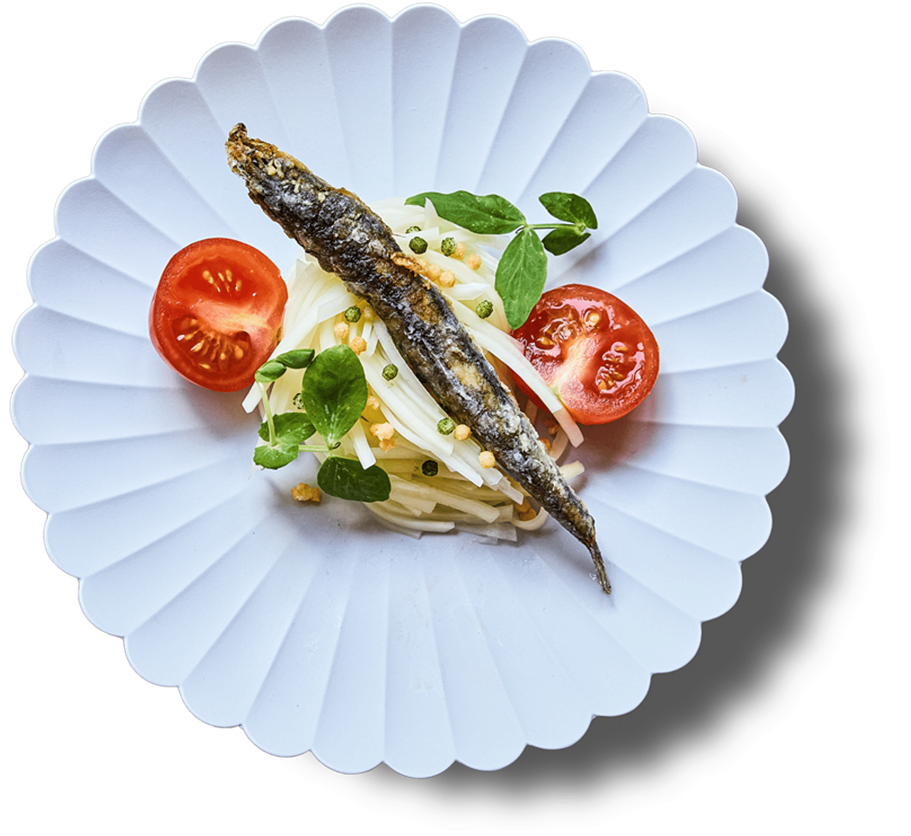 Noodles, grilled fish, cherry tomatoes, greens, and nuts served on a white plate.
